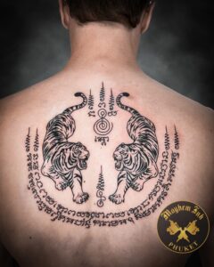 Tattoo aftercare during a Phuket holiday on a Sak Yant twin tigers.